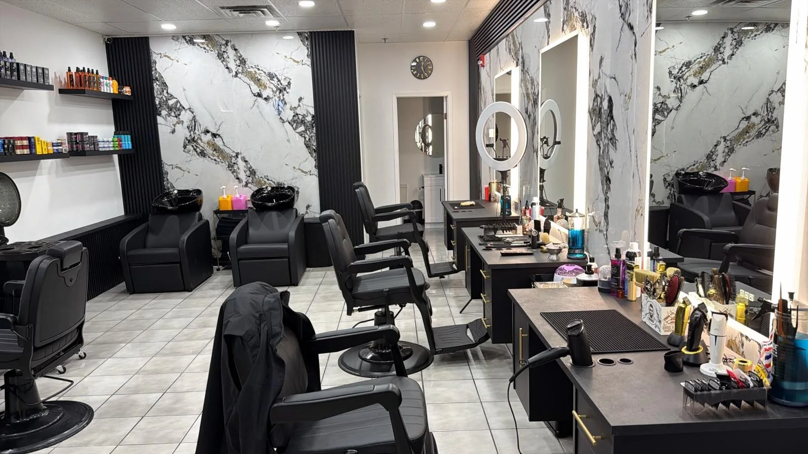 Barber stations and wash chairs inside Timspire Barbershop